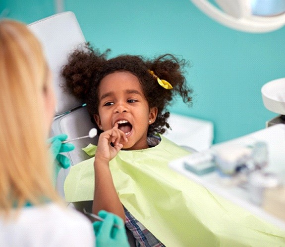 Woman helping her son brush teeth at Age One Visit in Sycamore, IL