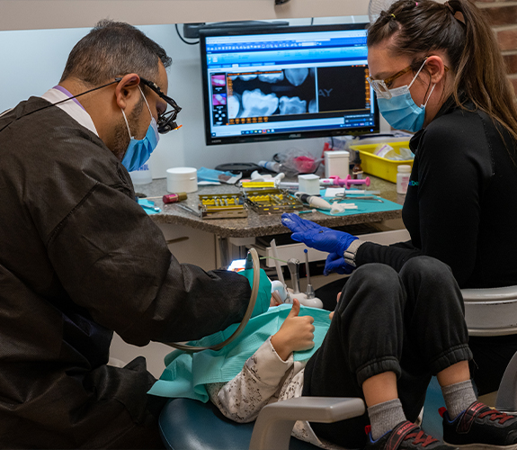 Patient receiving dental sealant treatment