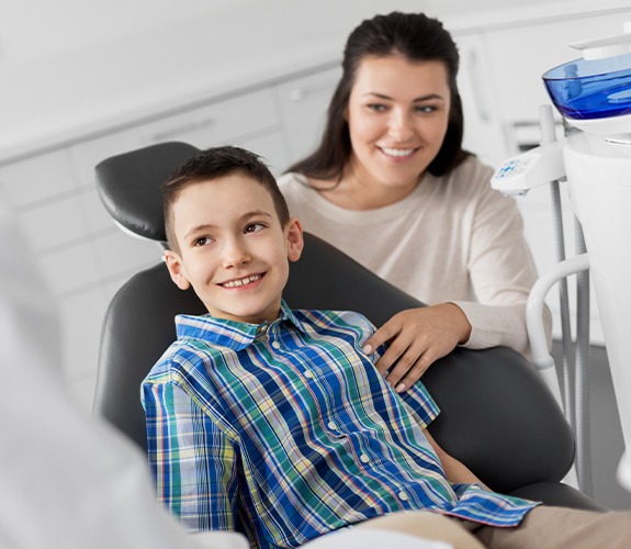Little boy smiling at dentist after pulp therapy