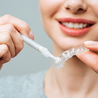 Woman using a custom take-home whitening kit