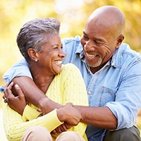 Couple smiling with dental implants in Sycamore