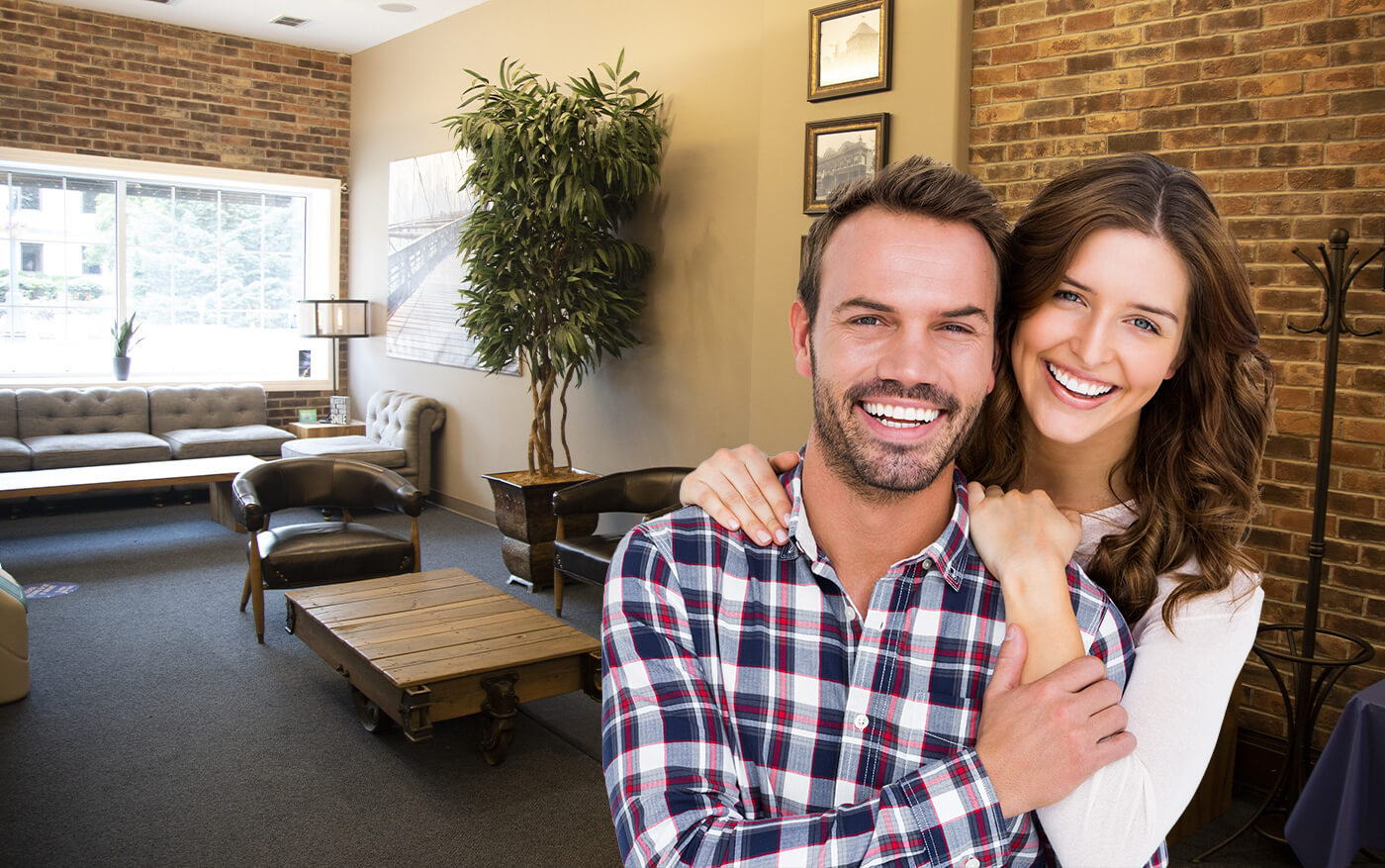 Smiling man and woman in dental office waiting room