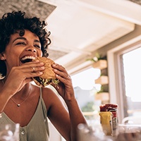 Woman enjoying a hearty sandwich