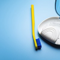An  aligner in a protective case and a toothbrush