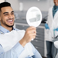 Man looking in the mirror at his smile