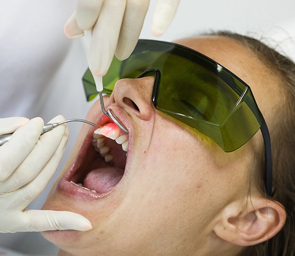 Patient receiving soft tissue laser dentistry treatment