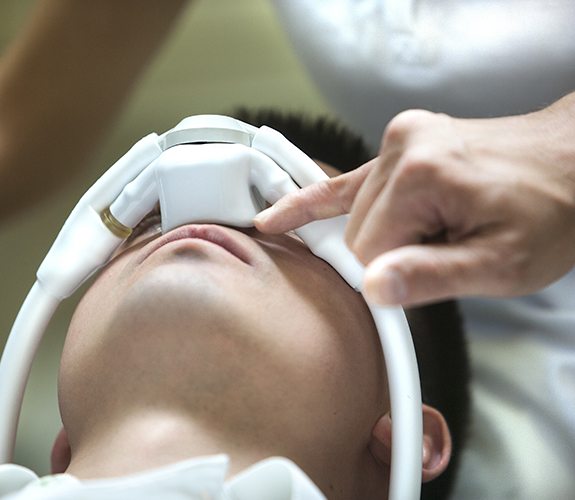 Patient receiving dental care with nitrous oxide sedation dentistry mask in place