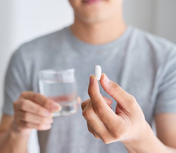 Man holding an oral conscious dental sedation pill