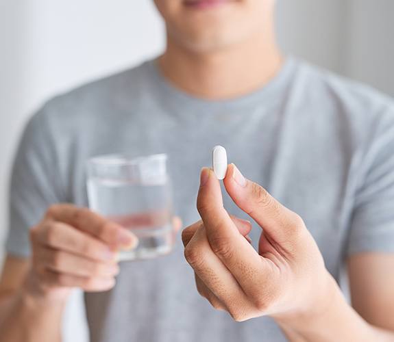 Man holding an oral conscious dental sedation pill