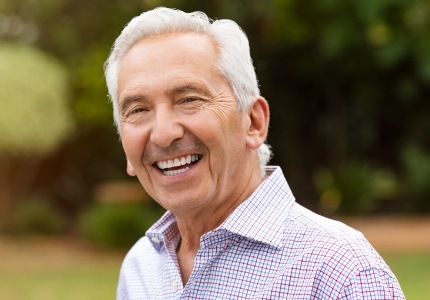 Man with healthy smile after replacing missing teeth