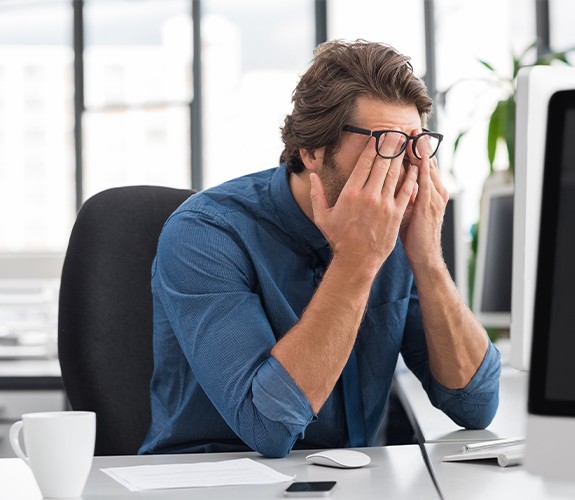 Tired man in need of sleep apnea treatment