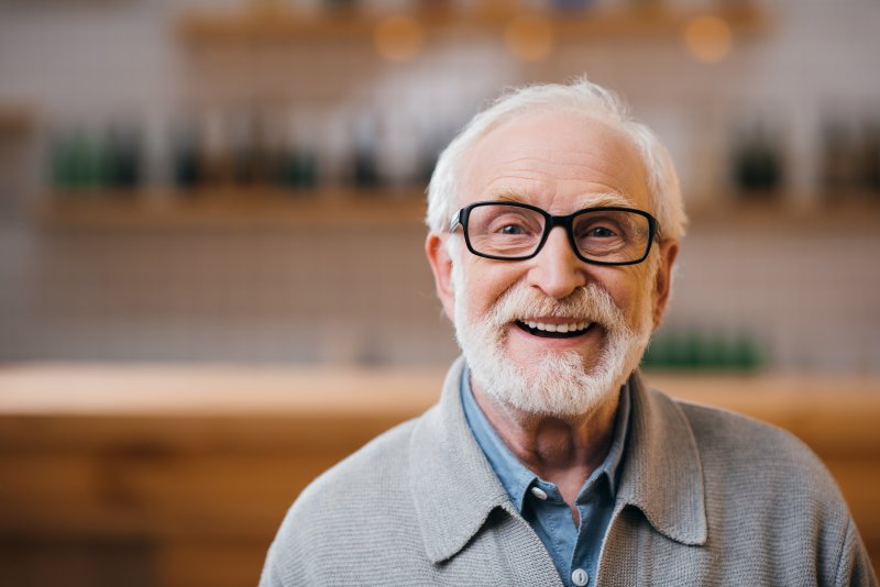 older man with dental implants  