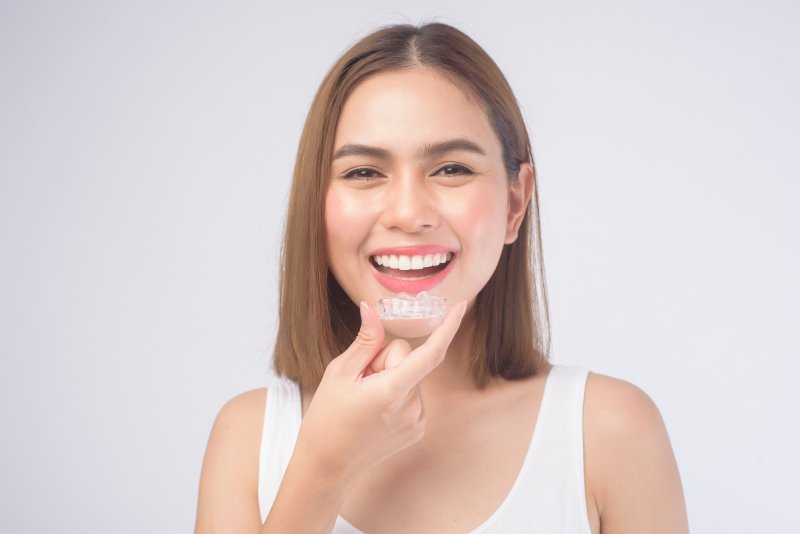 young woman with Invisalign aligner